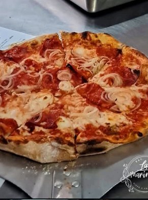 Hand-shaped dough on the peel, seconds before the oven