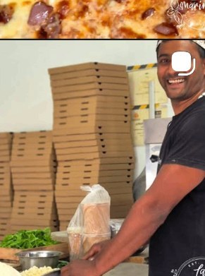 The pizzaiolo smiling next to a tower of takeaway pizza boxes