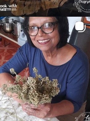 Home-dried herbs held up with a smile at La Marinara