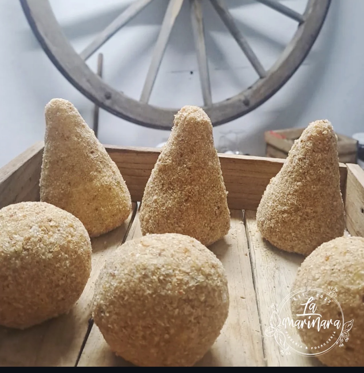 Breadcrumbed croquettes and arancini ready to fry at La Marinara