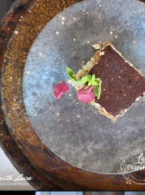 Chocolate dessert plated on a stone tray