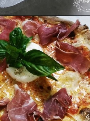 Pizza with prosciutto crudo, mozzarella and basil